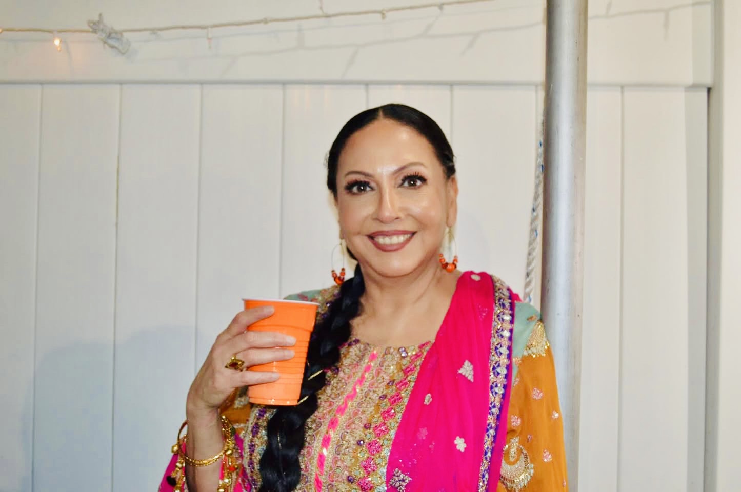 Author Zerena Khan smiling in a colorful traditional dress.